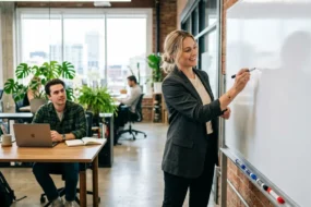 Marketing professional planning content repurposing strategy on a whiteboard