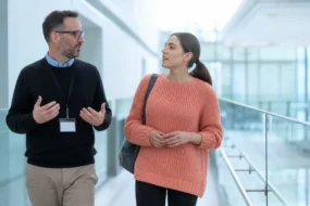 Advisor talks with student about an ai text detector in bright campus atrium